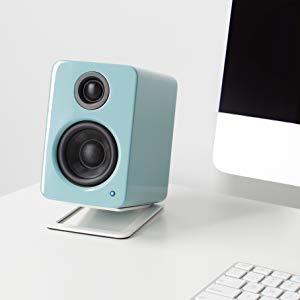 Kanto YU2 Gloss teal desktop speaker on Kanto S2 White desktop speaker stands next to iMac